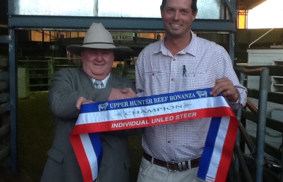 2014 Upper Hunter Beef Bonanza. Lachlan receivng Champion steer ribbon from judge Dennis Strachan